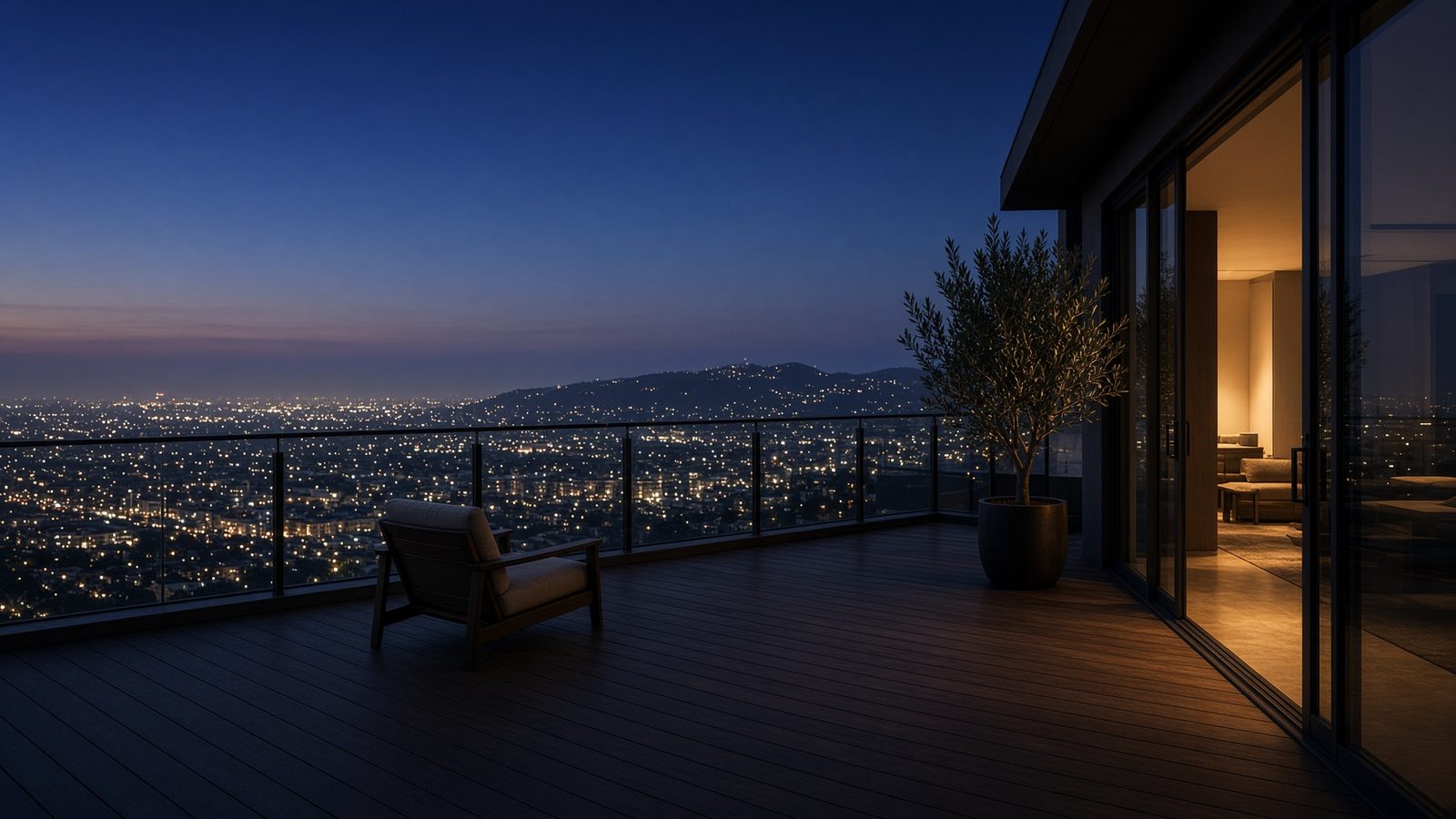 A rooftop terrace overlooking Los Angeles at dusk.